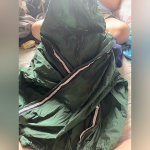 green windbreaker with strips on sleeves